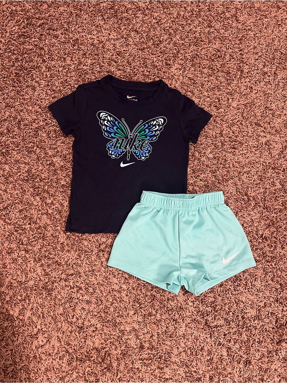 Nike Girls Navy Butterfly Graphic T-shirt and turquoise shorts